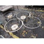 Four wrought steel circular occasional table frames, three inset with hardstone