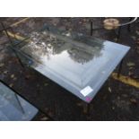 A modern wrought steel, glass topped coffee table having an antique door beneath the glass, 19 h, 62