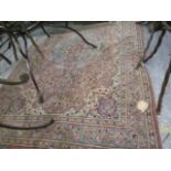 A hand woven Persian design rug having symmetrical designs, multiguard borders and tasselled ends,