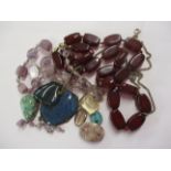 A red agate necklace and miscellaneous stones to include a heart shaped pendant