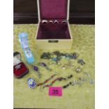 A quantity of costume jewellery to include earrings, white stone rings and a small jewellery box