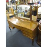 A modern French walnut dressing table having a triptych mirror and five drawers, standing on