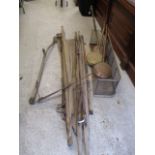 A mixed lot to include a fire fender, three copper warming pans, two WWII stretchers, a scythe and