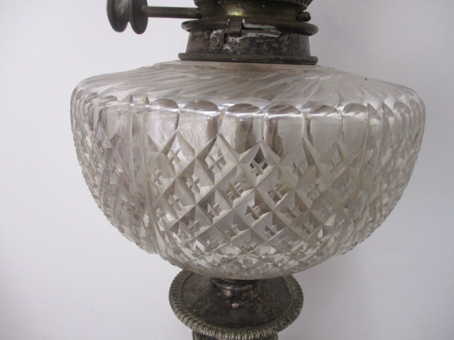 A late Victorian silver plated oil lamp having a clear glass reservoir with line cut decoration, - Image 4 of 5