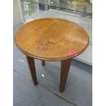 An early 20th century oak occasional table, with circular top on square, fluted legs, 22 1/4 h