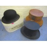 An early 20th century top hat and bowler hat, both cased