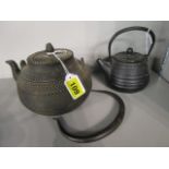 Two Japanese, cast iron Tetsubin's, the smaller with signature to base, 5 1/2h and the larger 7 3/