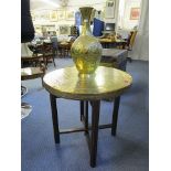 A Cairo ware brass topped, wooden folding table with a Middle Eastern brass vase, decorated with