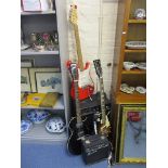 A Squires Strato red and white bodied guitar, together with two other guitars, a Squires practice