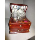 An Edwardian inlaid mahogany Tantalus with two cut glass whisky decanters, with key