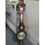 A 19th cenury rosewood cased wheel barometer with convex mirror, thermometer and dry/damp gauges, 38