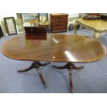 A reproduction mahogany D-end dining table with an extra leaf