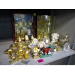 A large collection of brass, ceramics and glass cased novelty clocks to include examples fashioned