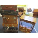 A collection of eight vintage suitcases to include leather suitcases