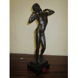 A contemporary bronze nude male figure, mounted on a black square base, 17 high