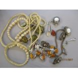 A mixed lot of costume jewellery to include a cultured pearl necklace, amber set silver necklace and