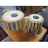 Two bongo drums, one ceramic the other metal