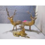 Three early 20th century, cast metal models of deer, the tallest 8 1/2 h