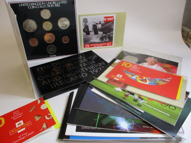 Three packets of coins to include un-circulated 1983 coins and thirteen Royal Mail stamp books