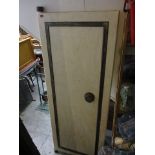 A cream painted soft wood door, with a wrought iron inset frame and a circular handle, 76 x 29