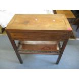 An early 20th century oriental hardwood, two tier table with inset drawer, standing on block feet,