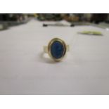 A 9ct gold ring set with an oval opal coloured cabochon, 6.8g