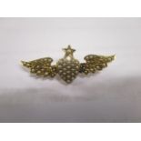 A Victorian 15ct gold brooch fashioned as a star and a heart flanked by a pair of wings, set with