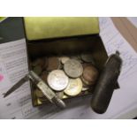 A selection of mainly British 20th century coinage in an old tin and a mother of pearl and steel pen