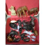 A collection of elephants and other animals to include a Victorian black glass Derbyshire lion