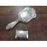 An Art Nouveau silver backed hand mirror and a silver purse with a fitted interior