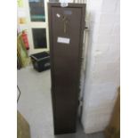 A metal gun cabinet, 54 1/4 h x 10 1/3 w