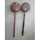 Two 19th century copper warming pans with turned, wooden handles