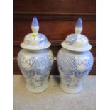 A pair of contemporary oriental blue and white vase and covers one A/F