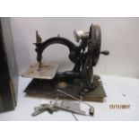 A Willcox & Gibbs automatic silent sewing machine, painted black with gilt decoration and plaque,