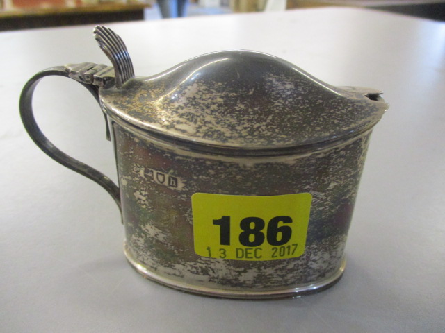 A silver London hallmarked mustard pot having an inset blue glass liner