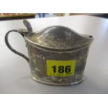 A silver London hallmarked mustard pot having an inset blue glass liner
