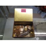 A selection of mainly British 20th century coinage in an old tin and a mother of pearl and steel pen