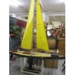 A fiberglass radio controlled model yacht with wooden trim and a Futaba controller, 94 h x 70w