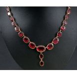 A 19th Century Garnet Riviere Necklace, close-set graduated oval-cut foil backed stones with