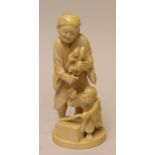 A Japanese ivory Okimono of a Puppeteer or Bunraku artist,By Minshi, Meiji PeriodStanding holding