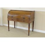 An early 19th Century mahogany Cylinder Desk enclosing pigeon holes, small drawers and slide out
