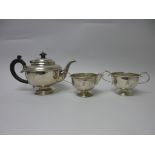 A George V silver plain circular three piece Tea Sevice engraved crest, Birmingham 1931