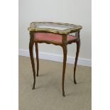 A French Bijouterie Table with gilt metal mounts having shaped and glazed hinged cover on slender