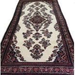 A large Persian style Carpet of multi-bordered design and having central lozenge surrounded by