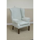 A Georgian style Wing Armchair with pale blue upholstery on square supports
