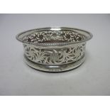 A George III silver pierced circular Coaster with floral and scroll design, gadroon rim and turned