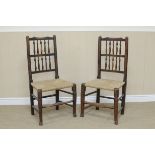A set of eight spindle back Dining Chairs with rush seats on turned tapering legs and pad feet