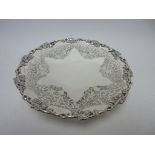 A Victorian circular Salver with scroll and rosette engraving, pierced floral swag and beaded border