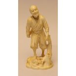 A Japanese ivory Okimono of a FarmerMeiji Period,Walking across uneven ground beside a gnarled