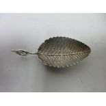 A George III silver Caddy Spoon with leaf bowl and coiled handle, London 1801, maker: Elizabeth